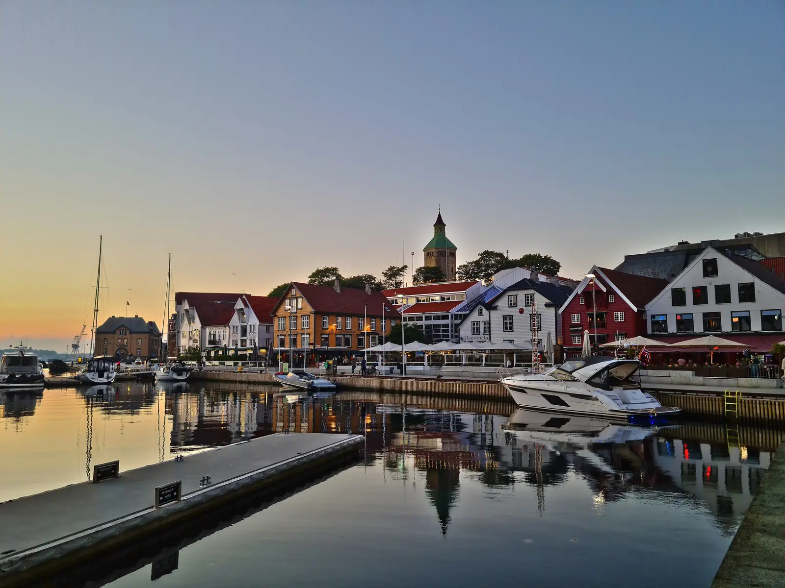 Vågen harbour in Stavanger at sunrise, with the Valberg tower and the sea houses along the quay